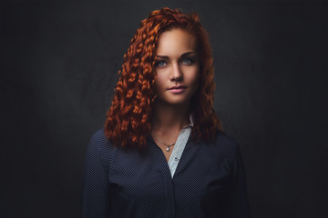 Redhead female supervisor dressed in an elegant suit.