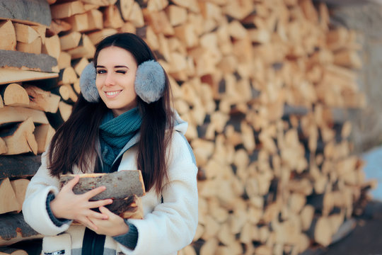 Winking Girl in Front of Fire Wood Stack Ready for Winter