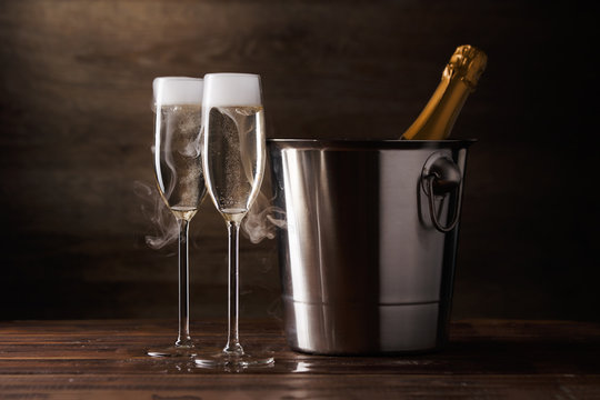Image of two wine glasses with sparkling wine, iron bucket