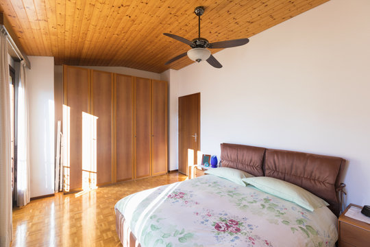 Bedroom with floor and wooden ceiling