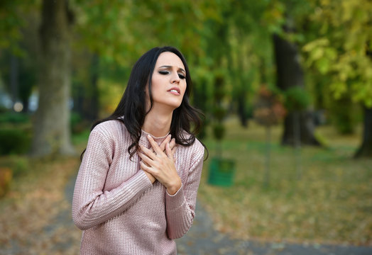woman heartache in a park in autumn