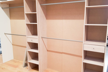 a part of close wide wooden dressing room, interior of a modern house