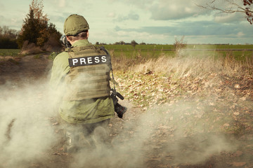 Photographer in war conflict field zone safety dressed
