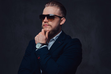 Fototapeta premium A man dressed in a suit and sunglasses.
