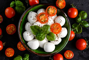 Basil, tomatoes and mozzarella for caprese salad, italian food background