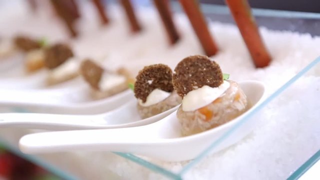 Catering for party. Close up of appetizers at corporate event on white plates.