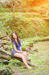 Asian girl sit down path in Bamboo forest