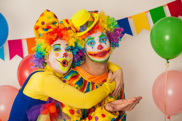 Two cheerful clowns. Birthday for children. Bright clown and clowness.