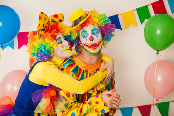 Two cheerful clowns. Birthday for children. Bright clown and clowness.