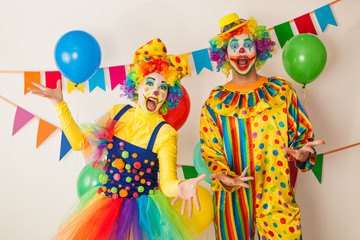 Two cheerful clowns. Birthday for children. Bright clown and clowness.