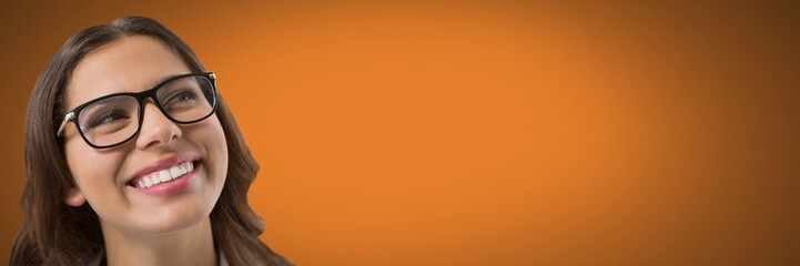 Woman looking up with orange background and glasses