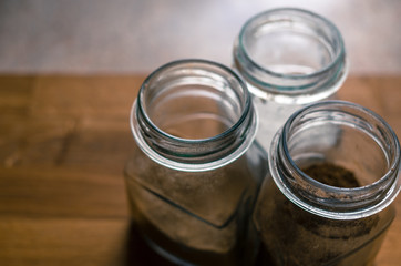 Three jar with spices on the natural wooden table