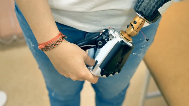 Real robotic prosthetic connected to a human hand. 4K.