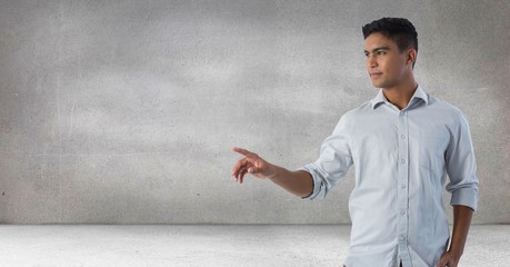 Businessman touching air in front of grey background