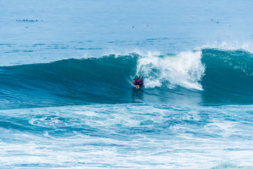 Bodyboarder surfing ocean wave