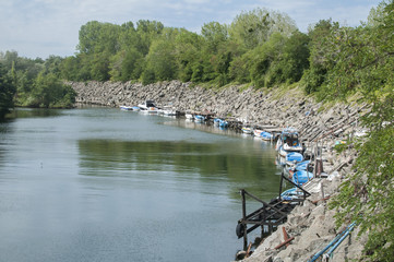 View from sea bay with moored obsolete fishing boats in calm waters