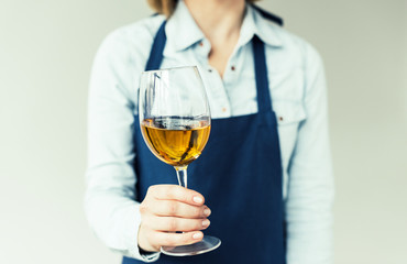 woman holding glass of white wine