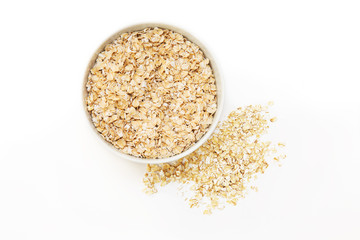 oat flakes in a white bowl on a white background