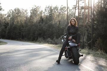 Naklejka premium Sexy girl biker and cafe racer motorcycle