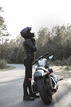 Sexy girl biker and cafe racer motorcycle