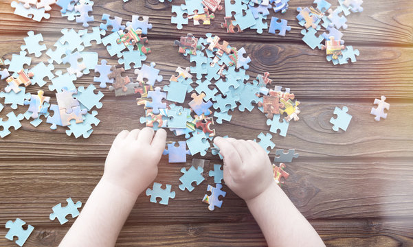 hand puzzles on a wooden background