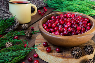 Berries cranberries, drink, jam spruce branches, cones on a dark background with a copy of the space
