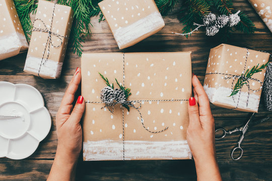 Woman Wrapping Christmas Presents In A Crafty Way