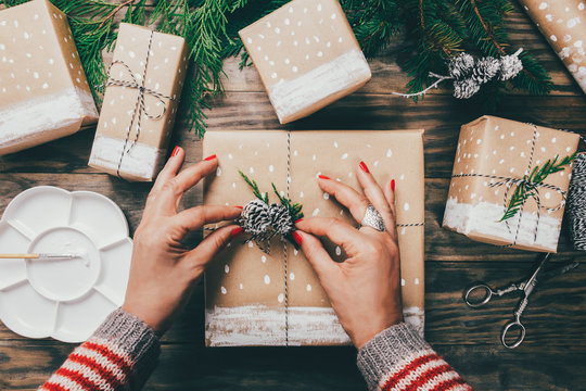 Woman wrapping Christmas presents in a crafty way
