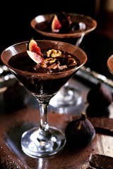 Chocolate mousse dessert with cinnamon, walnuts and figs