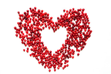 Heart from cranberries on a white background isolate top view of a flat with copy space