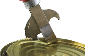 old rusty metal knife opens a metal tin can on white isolated background