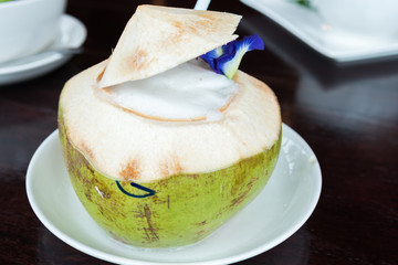 Coconut shake or Coconut smoothie in Coconut fruit on table