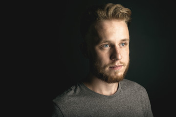 Fototapeta premium portrait of young man above black background
