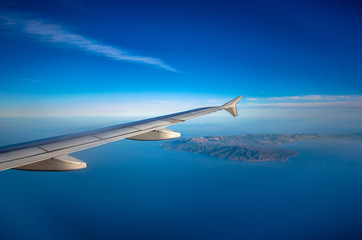 Naklejka na ściany i meble Amazing view from the plane window at the sky.Flight over the aegean sea.