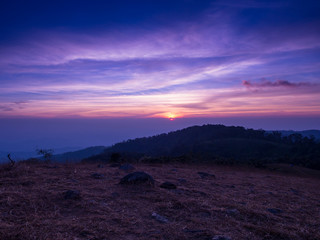 The hiding sun behind the mountain with colorful sky in Mon Jong, Chiangmai, Thailand.