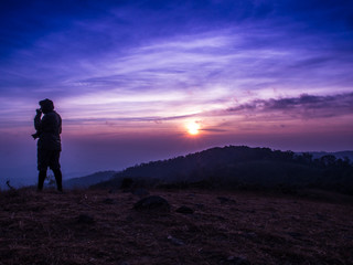 Fototapeta na wymiar The traveler on the Mon Jong mountain with the sun rising.