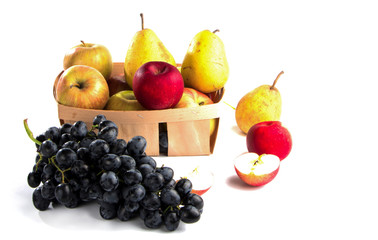 autumnal fruit in basket isolated on white background