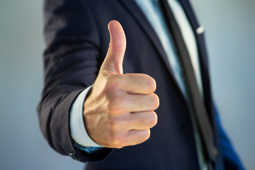 Businessman giving a thumb up on a color background