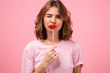 Funny woman isolated over pink background posing with fake lips
