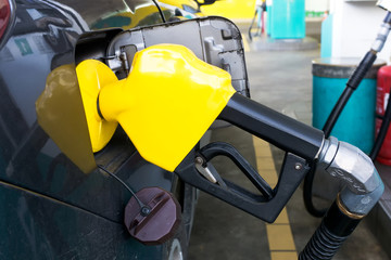 Close up of fuel nozzle refueling at the a gas station in Kota Kinabalu, Sabah Borneo, Malaysia.