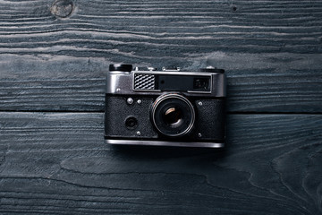 Camera retro. On a wooden surface. Top view. Free space for your text.
