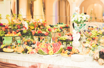 Delicious sweets on wedding candy buffet with desserts, cupcakes