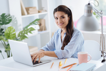 Delighted attractive woman looking at you