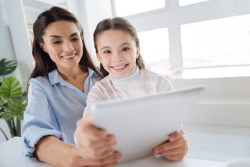 Cute positive girl using a tablet