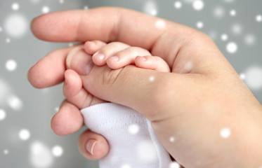 close up of mother and newborn baby hands