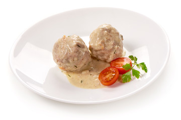 Meatballs with creamy sauce, isolated on white background