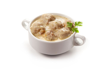 Meatballs with creamy sauce, isolated on white background