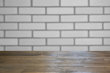 Blurred background. Empty tabletop and defocused brick wall background for display or montage your products.