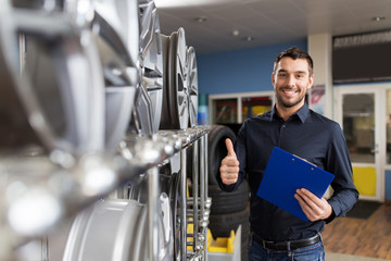 auto business owner and wheel rims at car service