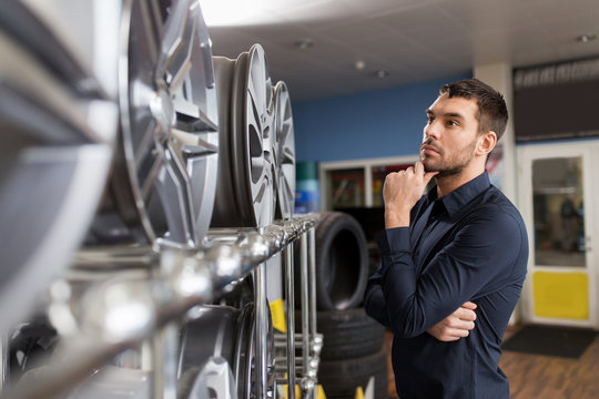 male customer choosing wheel rims at car service